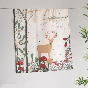 45x70 cm cotton tea towel with reindeer print folded beside holiday decor