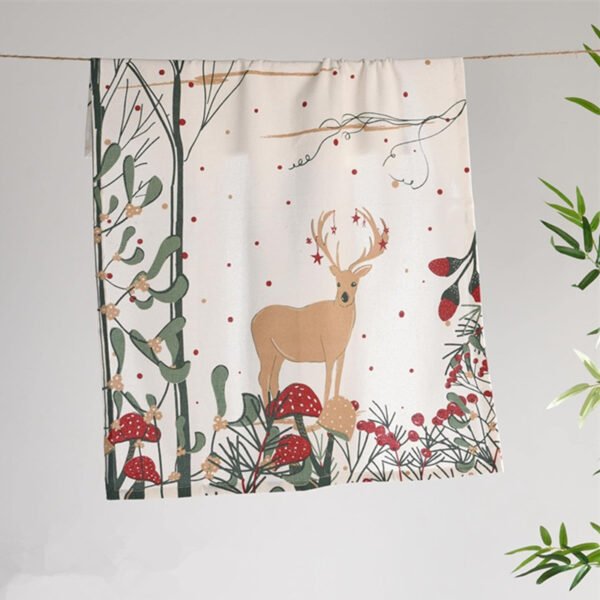 45x70 cm cotton tea towel with reindeer print folded beside holiday decor (1) 45x70 cm cotton tea towel with reindeer print folded beside holiday decor