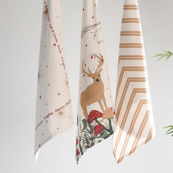 45x70 cm cotton tea towel with reindeer print folded beside holiday decor (4) 45x70 cm cotton tea towel with reindeer print folded beside holiday decor