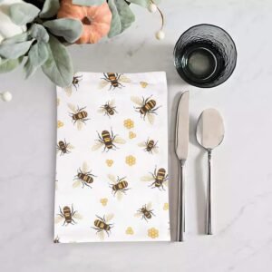 Bee print cotton napkin folded on rustic dining table