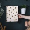 Bee print cotton napkin folded on rustic dining table