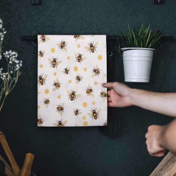 Bee print cotton napkin folded on rustic dining table