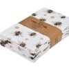 Bee print cotton napkin folded on rustic dining table