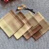 Brown check cotton napkin folded on rustic table setting