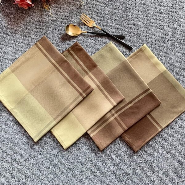 Brown check cotton napkin folded on rustic table setting