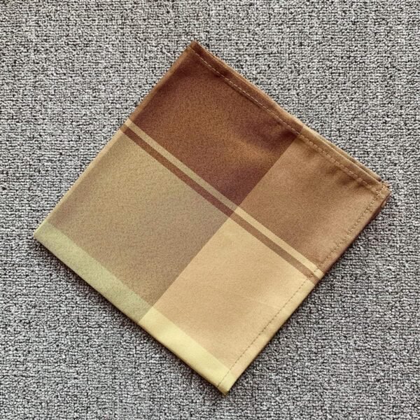 Brown check cotton napkin folded on rustic table setting