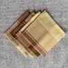 Brown check cotton napkin folded on rustic table setting