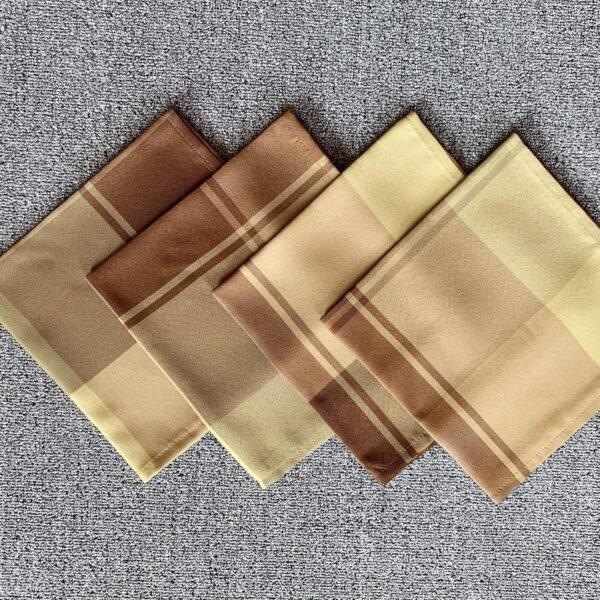Brown check cotton napkin folded on rustic table setting
