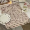 Thick custom cotton tea towel with embroidered logo on wooden table (3) Thick custom cotton tea towel with embroidered logo on wooden table
