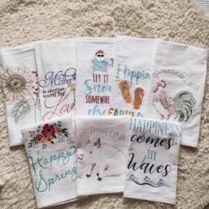 Thick custom cotton tea towel with embroidered logo on wooden table