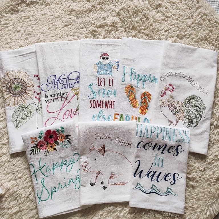 Thick custom cotton tea towel with embroidered logo on wooden table