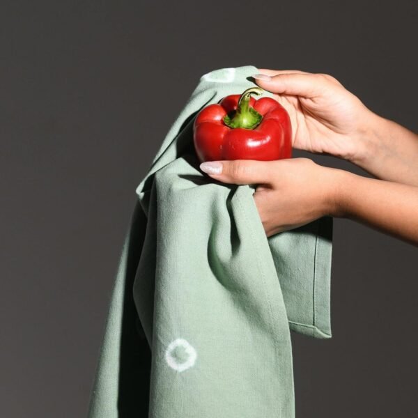 Tie-dye green cotton kitchen towel with unique pattern (8) Hands holding red pepper and towel