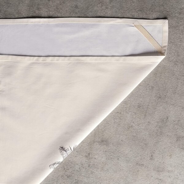 Vibrant printed cotton napkin folded on table with utensils