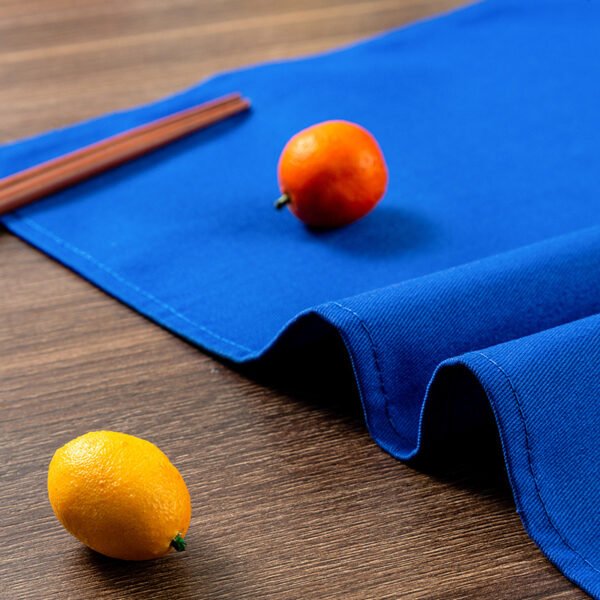 blue cotton napkin (1) Blue solid cotton napkin folded neatly beside tableware