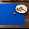 blue cotton napkin (4) Blue solid cotton napkin folded neatly beside tableware