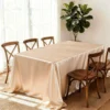 Elegant table with satin tablecloth and chairs