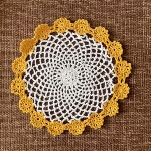 Handmade crochet starburst placemat with colorful edges
