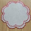 Linen embroidered placemat with red stitching