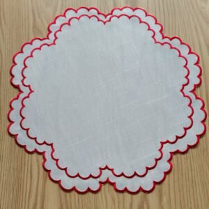 Linen embroidered placemat with red stitching