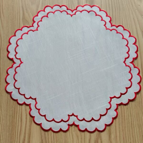 Linen embroidered placemat with red stitching