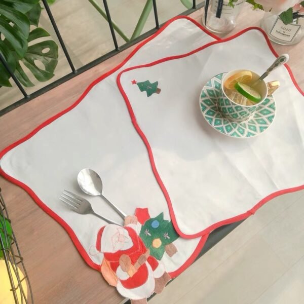 Scalloped edge embroidered cotton placemat on dining table