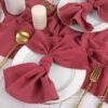 washed cotton napkin (9) Red washed cotton napkin neatly folded on restaurant table setting