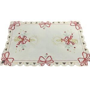 White embroidered placemat with candle and bell